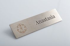 a metal name tag with the word anatassia on it