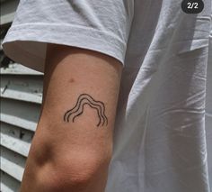 a person with a small tattoo on their arm