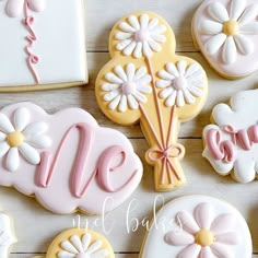 decorated cookies with the letter m and flowers on them are arranged next to each other