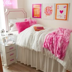 a bedroom with pink and white decor on the walls