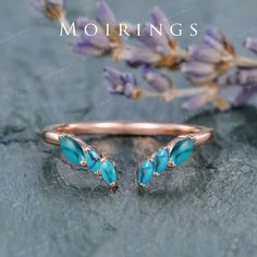 an image of a ring with blue stones on it and the words mohriings written in