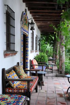 an outdoor patio with colorful cushions and tables