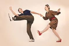 a man and woman are dancing together on a white background in the same outfit, one is wearing red shoes