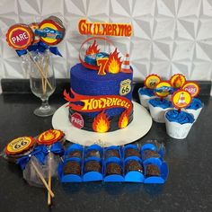 a birthday cake and cupcakes on a table