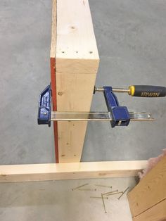 a couple of tools are on top of a piece of wood that is being worked on