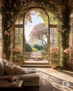 a living room with an arched window and flowers on the wall, along with couches