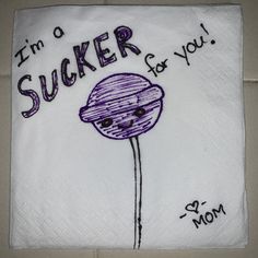 a white towel with a purple flower on it and the words i'm a sucker for you