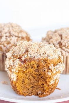 two muffins sitting on top of a white plate