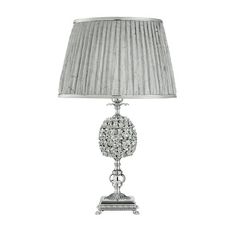 a silver lamp with a white shade on it