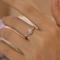 a woman's hand with a diamond ring on it