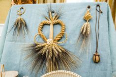 an arrangement of wheat stalks and other items displayed on a blue table cloth in a room