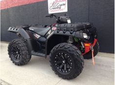 a black four wheeler parked in front of a building