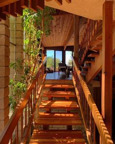 a wooden staircase leading up to an open floor plan