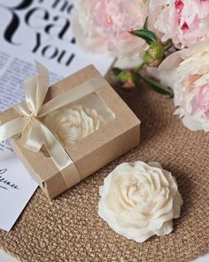 a gift box and some flowers on a table