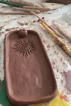 a chocolate tray sitting on top of a table next to some paint and crayons