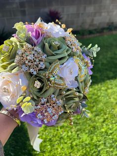 a bridal bouquet with brooches and flowers