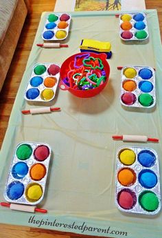 an image of a table with paintbrushes on it and a bowl of candy