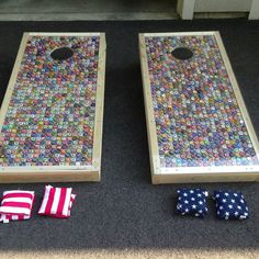 two cornhole boards with american flags on the floor next to one that has been made out of buttons