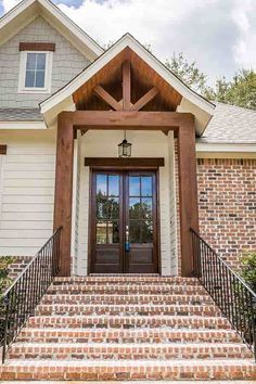 the front entrance to a house with brick steps