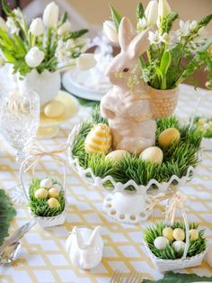 an easter table setting with flowers and eggs