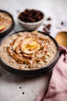 two bowls of oatmeal with apples on top