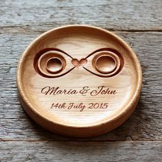 a wooden box with two wedding rings on it