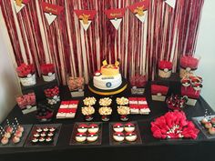 the dessert table is set up with cupcakes and candy