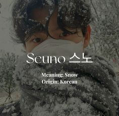 a man wearing a face mask covered in snow with the words seungo written on it