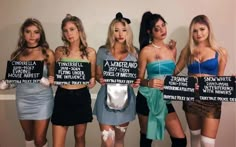 four women dressed up in costumes holding signs that say,'this is the most terrible thing i have ever seen '