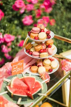 three tiered trays filled with pastries and watermelon slices