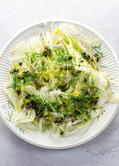 a white plate topped with cabbage and fennel