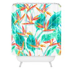 a shower curtain with colorful tropical leaves on the outside and pink backgrounnd