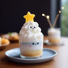 there is a small cupcake with whipped cream and a yellow star on top, sitting on a plate