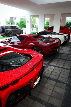 a row of red sports cars parked next to each other