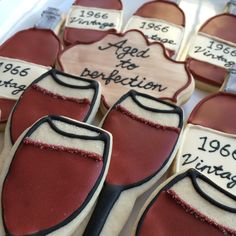 decorated cookies in the shape of shoes with names and dates on them are for sale