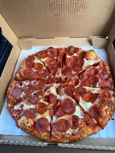 a large pepperoni pizza in a box