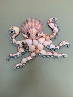 an octopus made out of seashells and glass beads