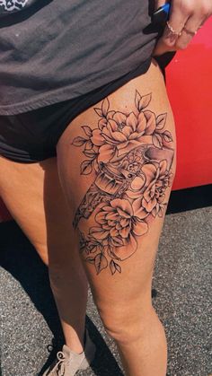 a woman's thigh with flowers on it