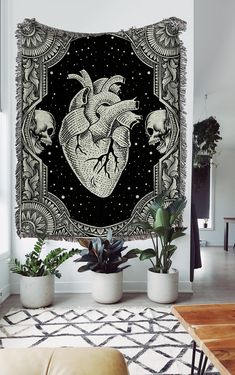 a tapestry hanging on the wall in a living room with plants and potted plants