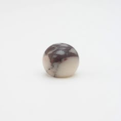 a marble ball sitting on top of a white surface