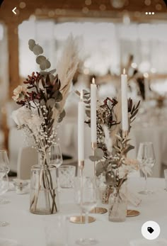 the centerpieces are decorated with flowers and candles