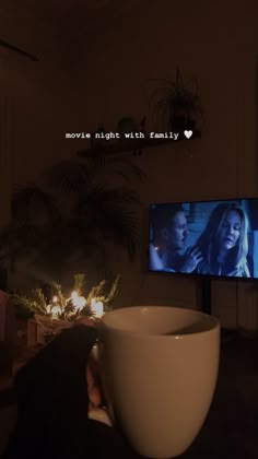 a large white bowl sitting in front of a tv