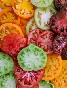 sliced tomatoes and cucumbers on a cutting board