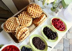 waffles and berries are served on plates for guests to eat at the reception