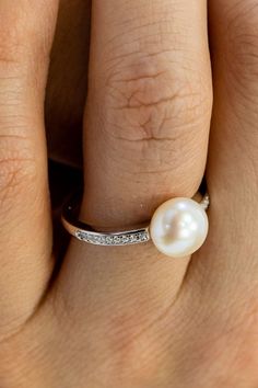 Similar to our Pearl Ring, this ring has a few subtle differences. The beautiful pavé band, set with 100% simulated diamond material (AAA CZ) continues farther along the circumference of the band. The solitaire pearl is simulated pearl material and measures approximately 1/4" and is set in a beautiful certified 925 sterling silver setting, and plated in rhodium. It will never turn your finger green or leave any sort of markings behind. Promise Ring Ideas, Pearl Promise Rings, Fake Diamond, Pearl Engagement Ring, Sterling Silver Promise Rings, Sterling Silver Wedding Band, Simulated Diamond Rings, Unique Jewelry Gifts, Solitaire Setting