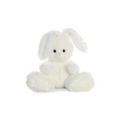 a white stuffed rabbit sitting on the ground