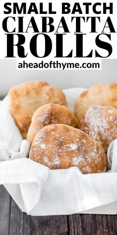 small batch ciabatta rolls with powdered sugar on top in a white basket