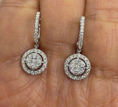 Beautiful Diamond Drop Earrings set with white and sparkling diamonds.  Just dangle below the lob, not too long.  Classy and pretty earring.  The hoop earring fits nice around the lobe.  These earrings you can easily dress up or down in them.  Excellent craftsmanship, all diamonds set smooth.  The cluster of round diamonds in the center measures 6mm.  The halo measures 9.8mm.  The length measures about 24mm.  The hoops snaps tightly for a secure fit. Genuine earth mined round brilliant cut diamonds total weight: 0.95 carats Clarity: I Color: G All white and shiny diamonds, no cloudy or yellowish stones  18K White Gold Earring 3.83 grams  Comes with gift box * We have been in the wholesale Jewelry business for over 30 years serving the community at the same location.  All diamonds we use ar Diamond Drop Earrings Classy, Gia Certified Dangle Diamond Earrings In White Gold, Gia Certified Dangle White Gold Diamond Earrings, Gia Certified Diamond Drop Earrings, Gia Certified White Gold Dangle Diamond Earrings, Gia Certified White Gold Drop Diamond Earrings, Dazzling White Diamond Dangle Earrings, White Diamond Drop Earrings With Vvs Clarity, White Brilliant Cut Dangle Diamond Earrings