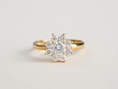 a yellow gold engagement ring with three diamonds