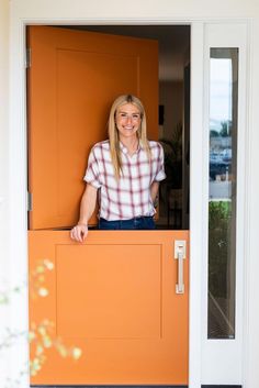 a woman is standing in the open door